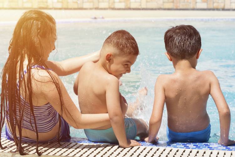 A group of children enjoy a day at the pool A group of children enjoy a day at the pool
