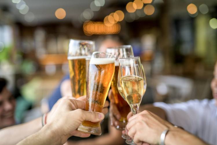 A group of friends cheers at happy hour 